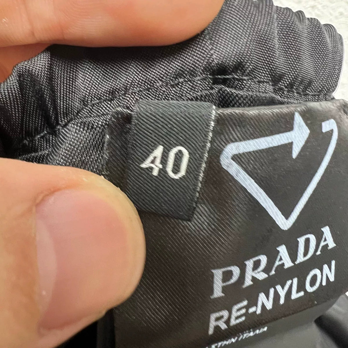PRADA metal triangle logo zip skirt