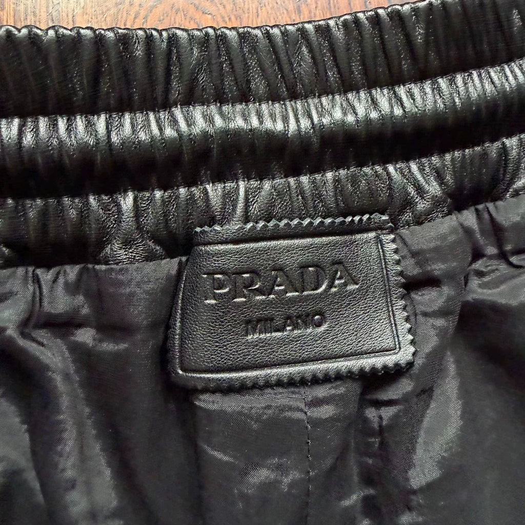 Prada triangular steel logo leather shorts
