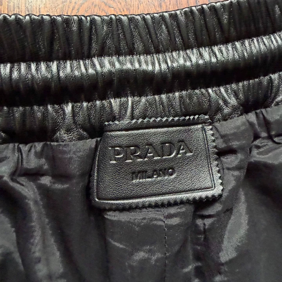 Prada triangular steel logo leather shorts