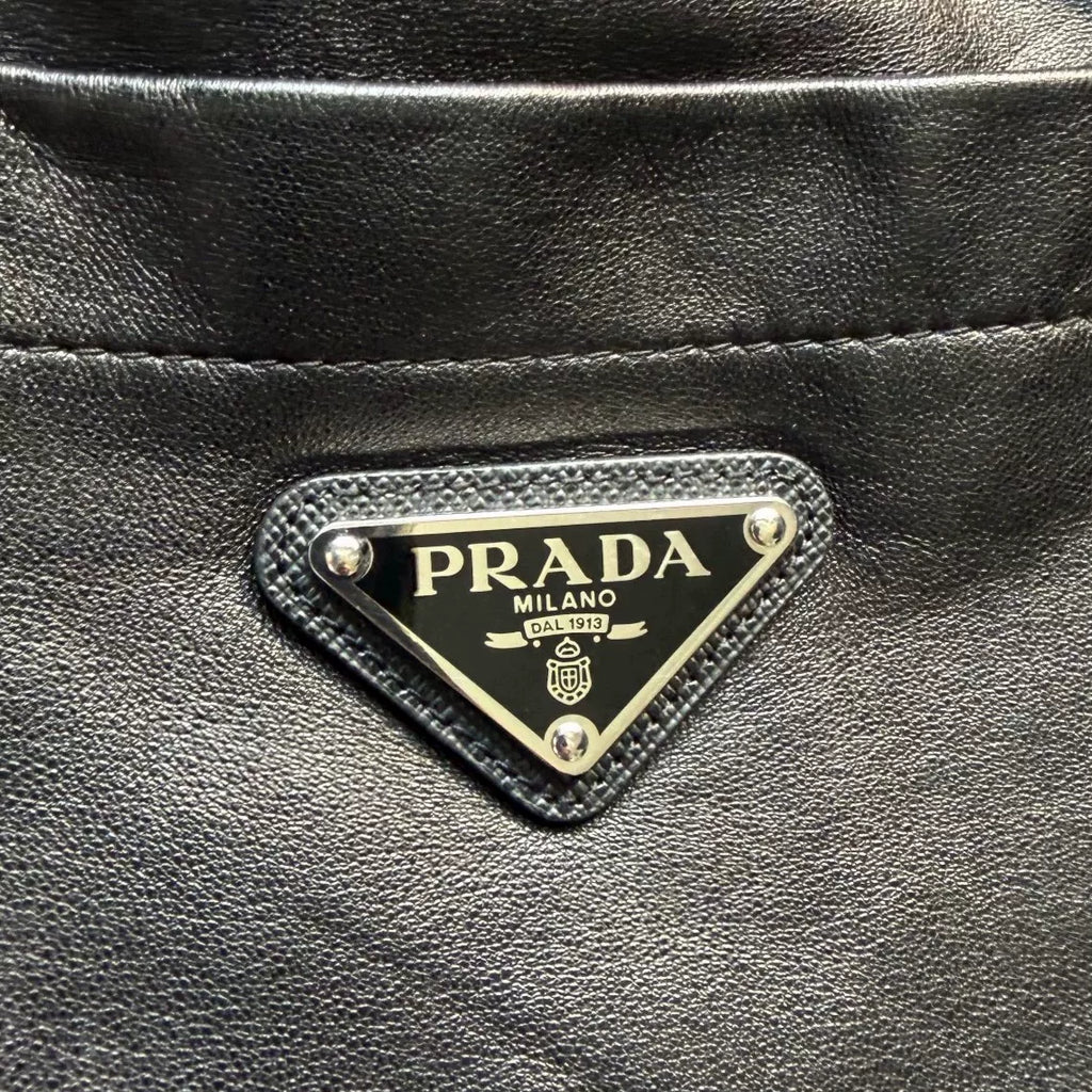 Prada triangular steel logo leather shorts