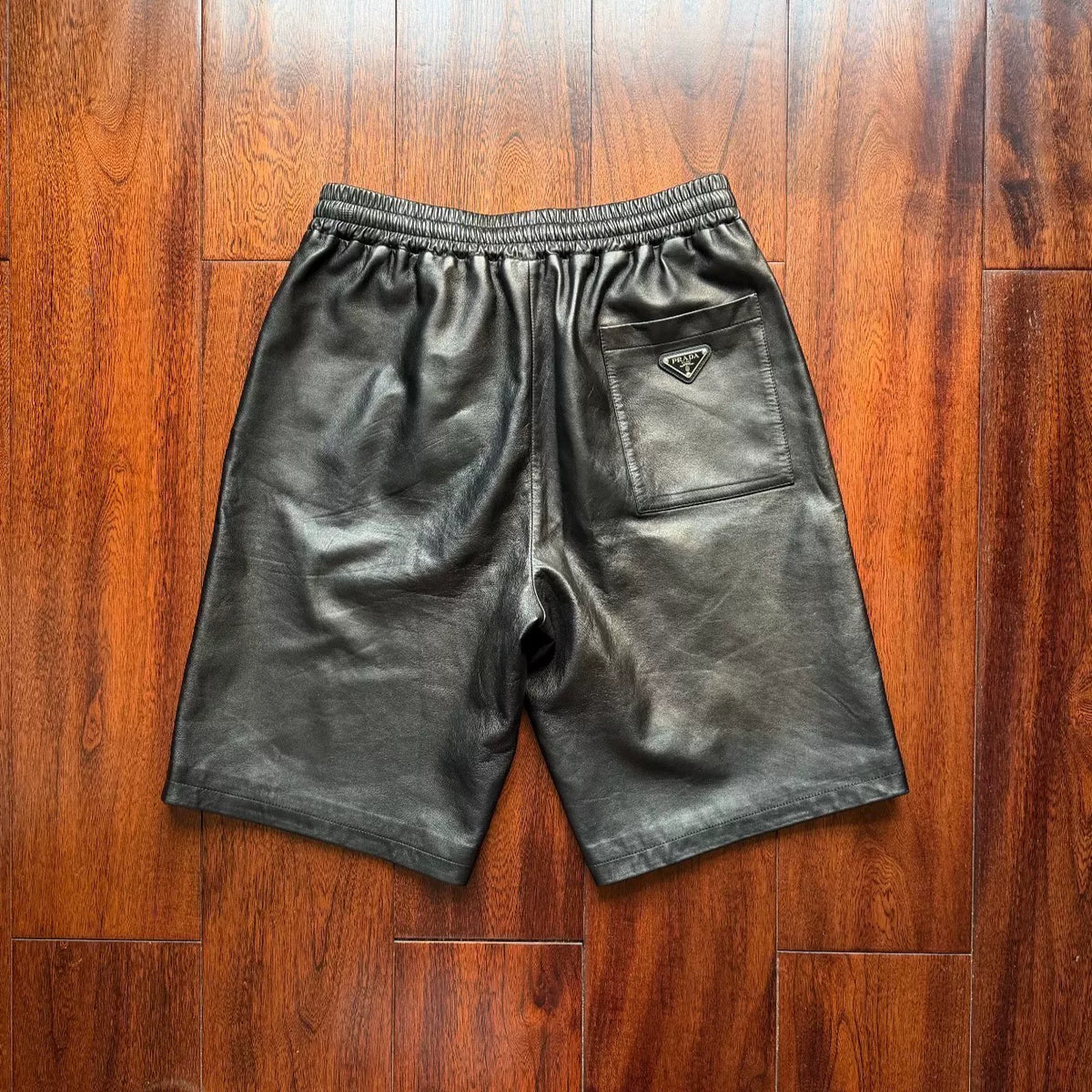 Prada triangular steel logo leather shorts