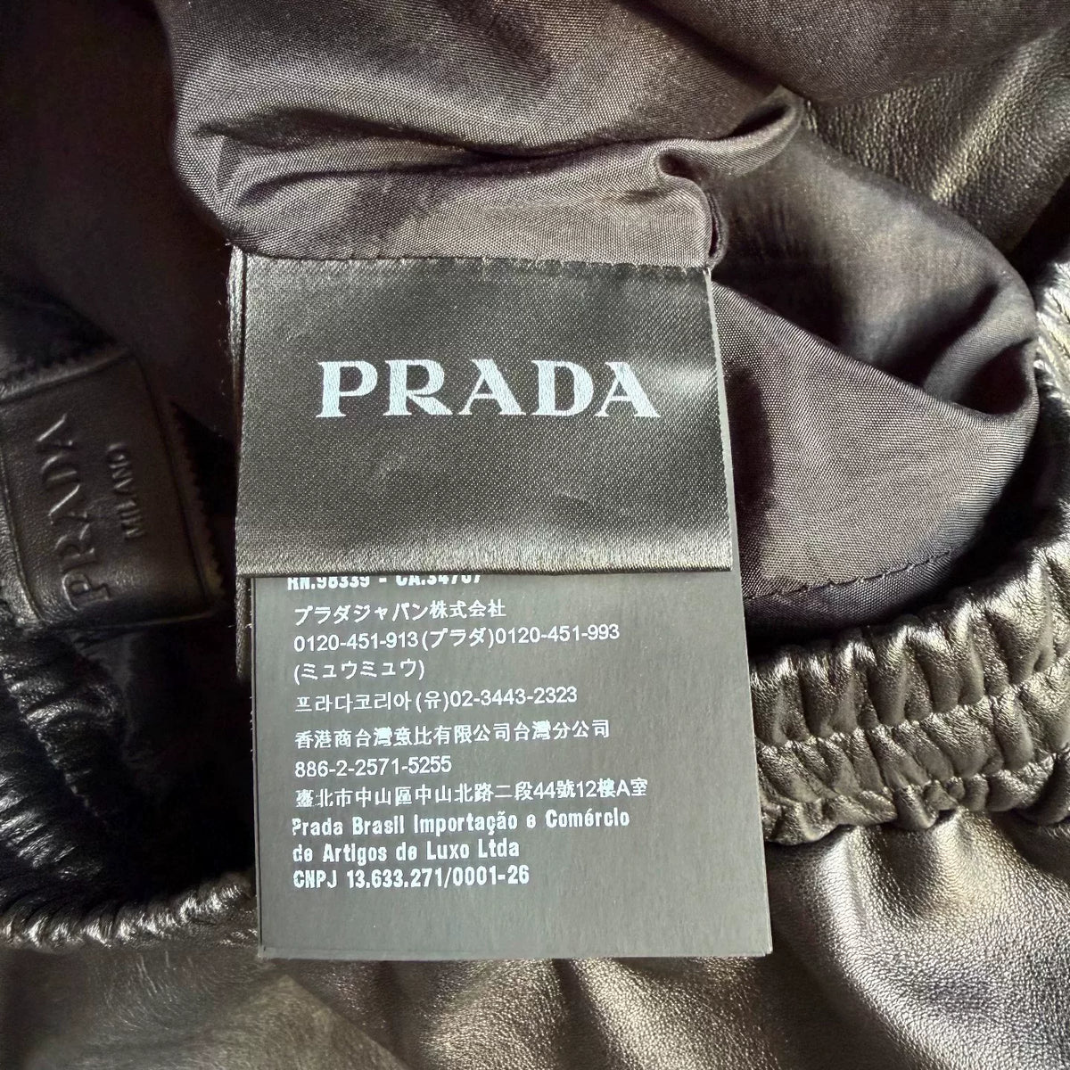 Prada triangular steel logo leather shorts
