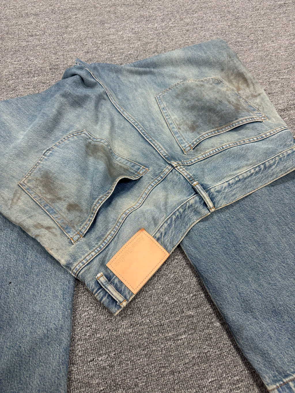 Acne Studios Mud-Dyed Ripped Denim Trousers