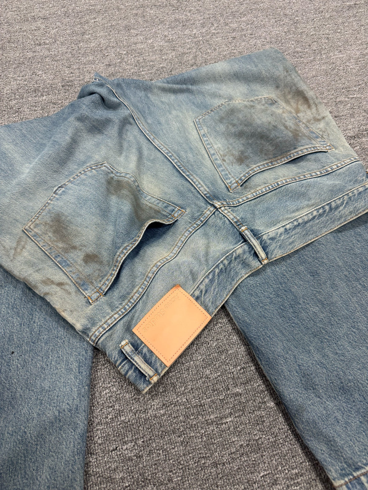 Acne Studios Mud-Dyed Ripped Denim Trousers